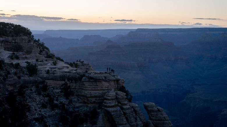 Tourists watch the sunset at Grand Canyon National Park in Grand Canyon, Arizona, US, on Tuesday, May 13, 2025. The new budget proposal from the US president would reduce the budget for the nation's national parks, monuments, historic sites, seashores and trails by nearly 25% and hand over many of those to the states, USA Today reports.