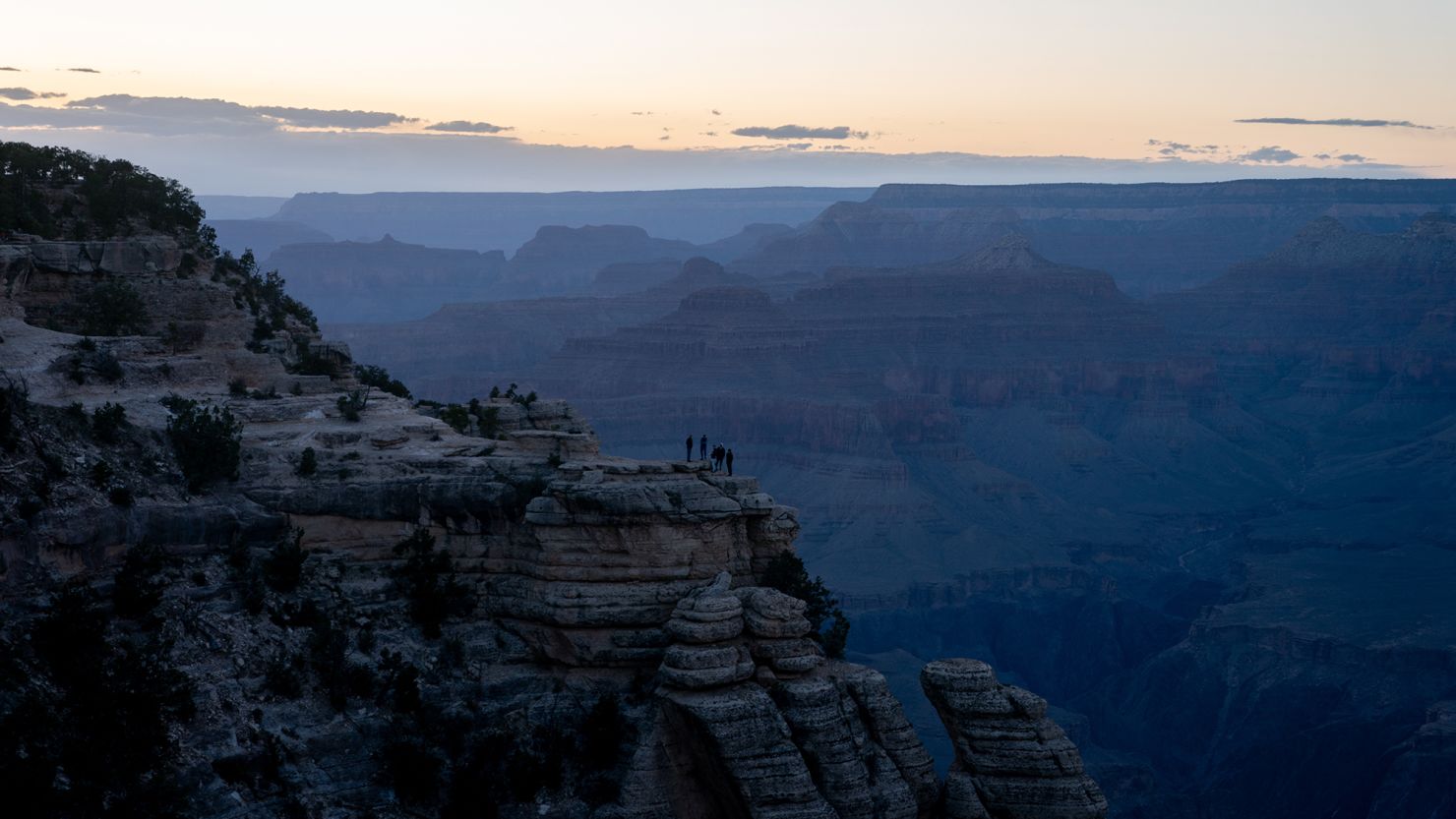 Tourists watch the sunset at Grand Canyon National Park on May 13. TikTokkers have posted videos advocating against moves by the Trump administration to cut funding for national parks and public lands.