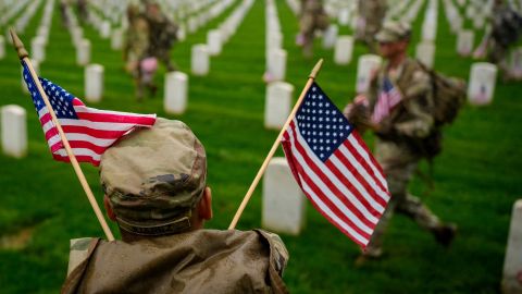ARLINGTON, VIRGINIA - MAY 22:  of the 3rd U.S. Infantry Regiment place flags at the headstones of U.S. military personnel buried at Arlington National Cemetery, in preparation for Memorial Day on May 22, 2025 in Arlington, Virginia. Nearly 1500 service  entered the cemetery at pre-dawn hours to begin the process of placing a flag in front of approximately 260,000 headstones. (Photo by Andrew Harnik/Getty Images)