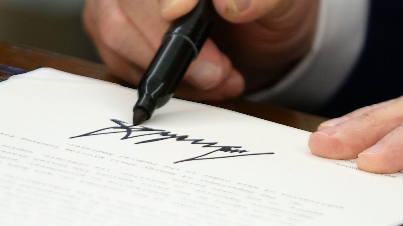 US President Donald Trump signs an executive order in the Oval Office of the White House in Washington, DC, US, on Friday, May 23, 2025.