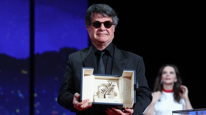 TOPSHOT - Iranian director and screenwriter and producer Jafar Panahi poses on stage after winning the Palme d'Or for the film "Un simple accident" (A Simple Accident) during the closing ceremony at the 78th edition of the Cannes Film Festival in Cannes, southern France, on May 24, 2025. (Photo by Valery HACHE / AFP) (Photo by VALERY HACHE/AFP via Getty Images)          