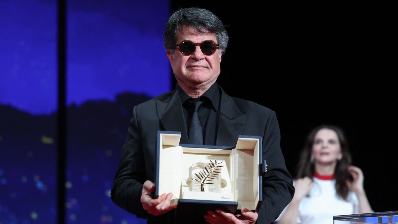 TOPSHOT - Iranian director and screenwriter and producer Jafar Panahi poses on stage after winning the Palme d'Or for the film "Un simple accident" (A Simple Accident) during the closing ceremony at the 78th edition of the Cannes Film Festival in Cannes, southern France, on May 24, 2025. (Photo by Valery HACHE / AFP) (Photo by VALERY HACHE/AFP via Getty Images)          