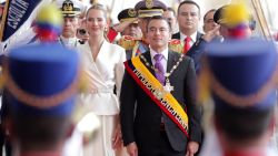 TOPSHOT - Ecuador's re-elected President Daniel Noboa (C) and his wife, First Lady Lavinia Valbonesi (L), receive honors upon their entrance to the Carondelet Palace after his inauguration at the National Assembly in Quito on May 24, 2025. Noboa, 37, was sworn in on Saturday for a new term that will run until 2029 in a country plagued by violence despite his iron fist policy against drug trafficking. (Photo by ARMANDO PRADO / AFP) (Photo by ARMANDO PRADO/AFP via Getty Images)          