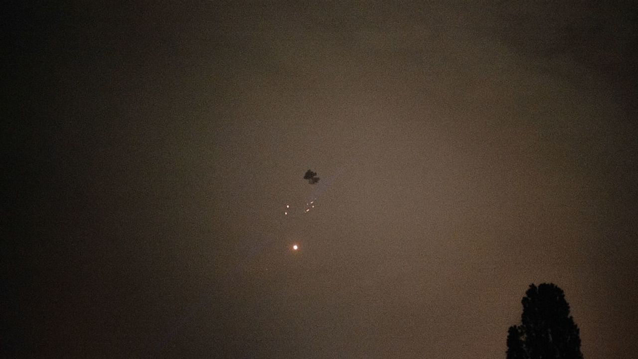 A cloud of smoke and burning debris falls on Kyiv after a Russian Shahed attack drone was shot down by air defences on 25 May 2025, amid the Russian invasion of Ukraine. Russian strikes killed at least 12 people in Ukraine overnight into May 25, 2025, officials said, as Kyiv and Moscow traded fire amid an ongoing major prisoner swap. (Photo by Florent VERGNES / AFP) (Photo by FLORENT VERGNES/AFP via Getty Images)          