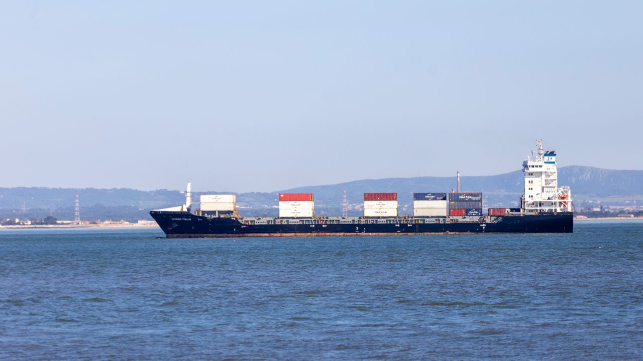A cargo ship loaded with containers sails near the coast in Lisbon, Portugal, on May 24, 2025. Trump's proposed 50% tariff on EU goods alarms exporters in Germany, Ireland, and Italy. The announcement triggers a decline in China-U.S. shipping traffic. (Photo by Luis Boza/NurPhoto via Getty Images)