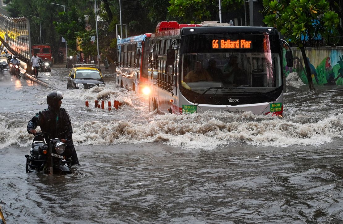 Vehicles wade through waterlogged road at Gandhi Market in the Sion area after heavy rain on May 25, in Mumbai, India.