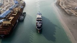 This aerial view shows a container ship cruising at the port of Umm Qasr in Iraq's southern city of Basra. Iraq was among the latest countries to receive a letter from President Donald Trump informing the nation of the rate its goods will be tariffed as of August 1, absent a trade deal.
