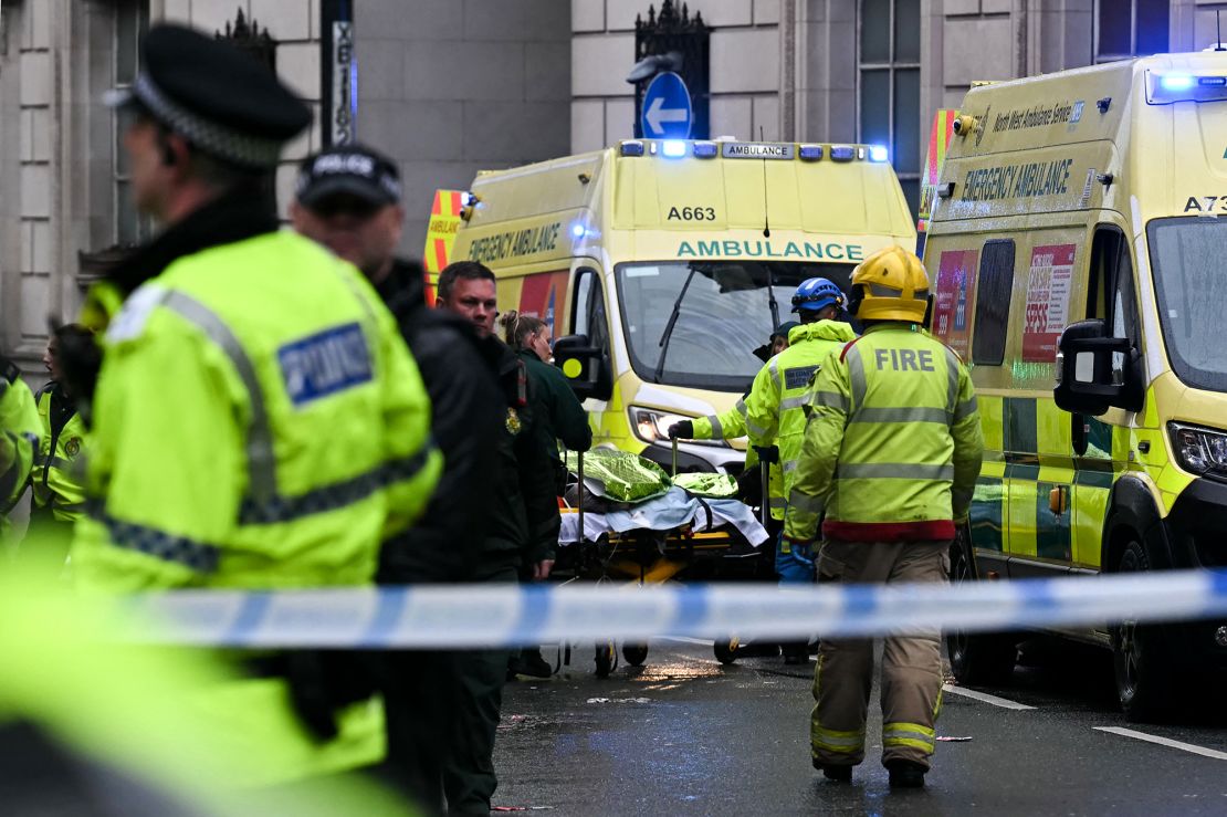Officers carry away injured people following the collision.