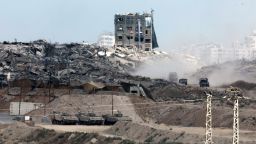 This picture taken from a position in southern Israel, on the border with the Gaza Strip, shows Israeli vehicles returning after operations on the besieged territory on May 27, 2025. Israeli Prime Minister Benjamin Netanyahu vowed May 26 to bring back all hostages, "living and dead", as Gaza rescuers said Israeli strikes killed at least 52 people in the war-battered Palestinian enclave. (Photo by Jack GUEZ / AFP) (Photo by JACK GUEZ/AFP via Getty Images)          
