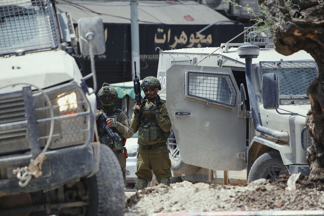 Israeli armored vehicles and soldiers are stationed in central Jenin, West Bank on Tuesday.