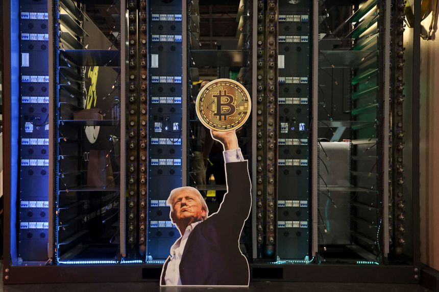 A cutout of President Donald Trump holding a Bitcoin is displayed on a group of servers during The Bitcoin Conference in Las Vegas on May 27.