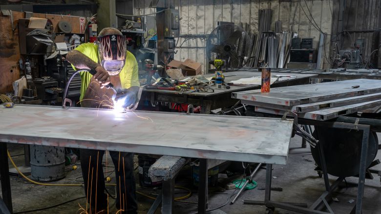 A worker arc welds a metal door during production at the Metal Manufacturing Co. facility in Sacramento, California, on May 27, 2025.