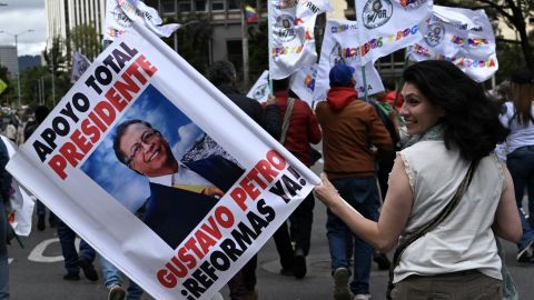 A woman holds an allusive sign during a march in favor of the reforms proposed by Colombia's President Gustavo Petro during a strike called by unions in Bogota, Colombia, on May 28, 2025. Thousands of Colombians took to the streets to the popular consultation that includes the expansion of labour and health rights, but which was blocked by the opposition in Congress. Petro is now promoting a referendum to allow citizens to decide, a proposal that has also been rejected in the legislature. (Photo by Raul ARBOLEDA / AFP) (Photo by RAUL ARBOLEDA/AFP via Getty Images)