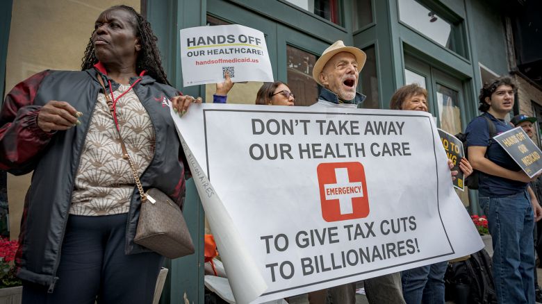 BROOKLYN, NEW YORK, UNITED STATES - 2025/05/29: Participants seen holding a banner at the protest. New Yorkers gathered outside House Representative Nicole Malliotakis office in Bay Ridge, Brooklyn to protest her decision to vote in favor to pass the so called Big Beautiful Bill, a bill that contains severe cuts to social services like healthcare, housing and food assistance federally funded programs and big tax cuts to billionaires and big corporations. (Photo by Erik McGregor/LightRocket via Getty Images)