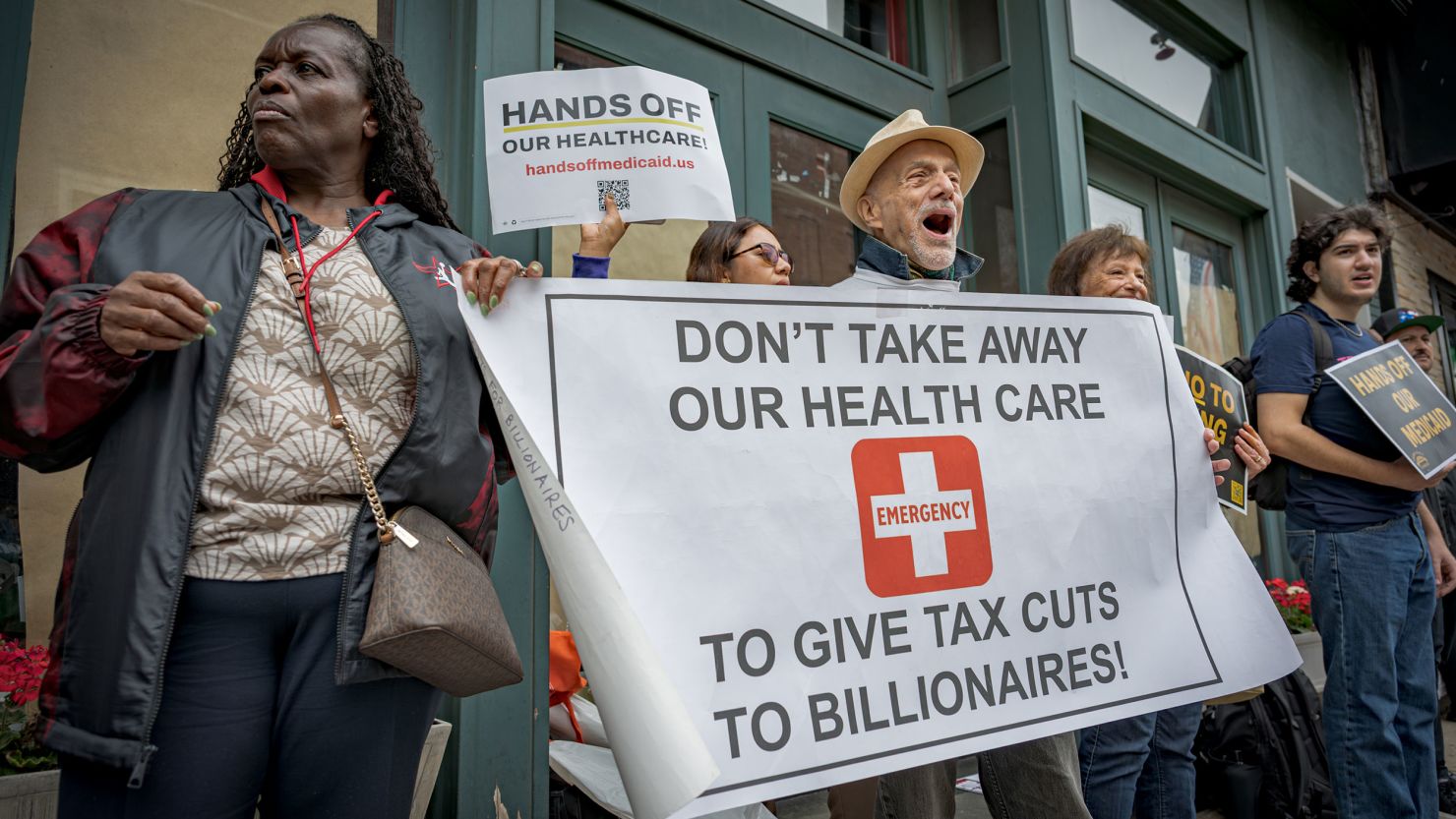 Demonstrators hold a banner outside Rep. Nicole Malliotakis' office in Bay Ridge, Brooklyn, protesting her decision to vote in favor of the Republican budget bill on May 29.