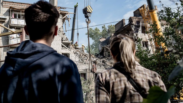 People look at a damaged residential apartment building after a Russian drone attack in Mykolaiv, Ukraine, on May 25.