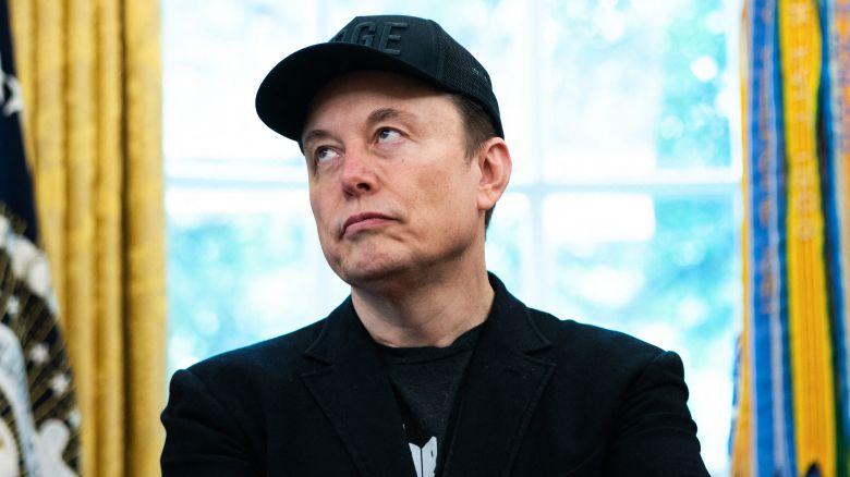 Elon Musk looks on during a news conference with US President Donald Trump in the Oval Office of the White House in Washington, DC, on May 30, 2025. Musk, who stormed into US politics as President Trump's chainsaw-brandishing sidekick, announced on May 28 that he is leaving his role in US government, intended to reduce federal spending, shortly after his first major break with the President over Trump's signature spending bill. (Photo by Allison ROBBERT / AFP) (Photo by ALLISON ROBBERT/AFP via Getty Images)          