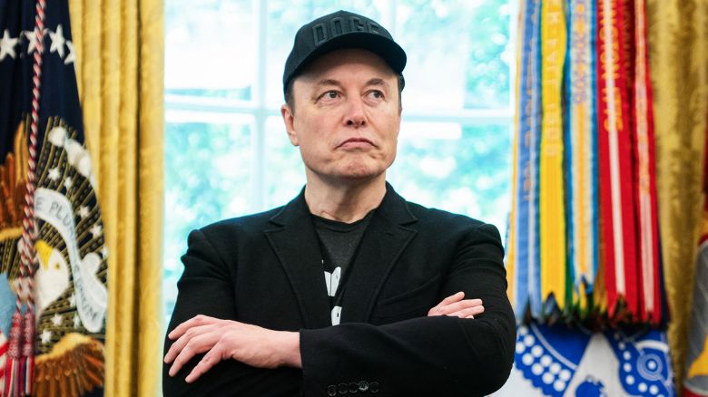 Elon Musk looks on during a news conference with US President Donald Trump in the Oval Office of the White House in Washington, DC, on May 30, 2025. Musk, who stormed into US politics as President Trump's chainsaw-brandishing sidekick, announced on May 28 that he is leaving his role in US government, intended to reduce federal spending, shortly after his first major break with the President over Trump's signature spending bill.