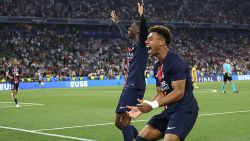 Paris Saint-Germain's French midfielder #14 Desire Doue (R) celebrates with Paris Saint-Germain's French forward #10 Ousmane Dembele (C) after scoring PSG's fourth goal during the UEFA Champions League final football match between Paris Saint-Germain (PSG) and Inter Milan in Munich, southern , on May 31, 2025. (Photo by FRANCK FIFE / AFP) (Photo by FRANCK FIFE/AFP via Getty Images)