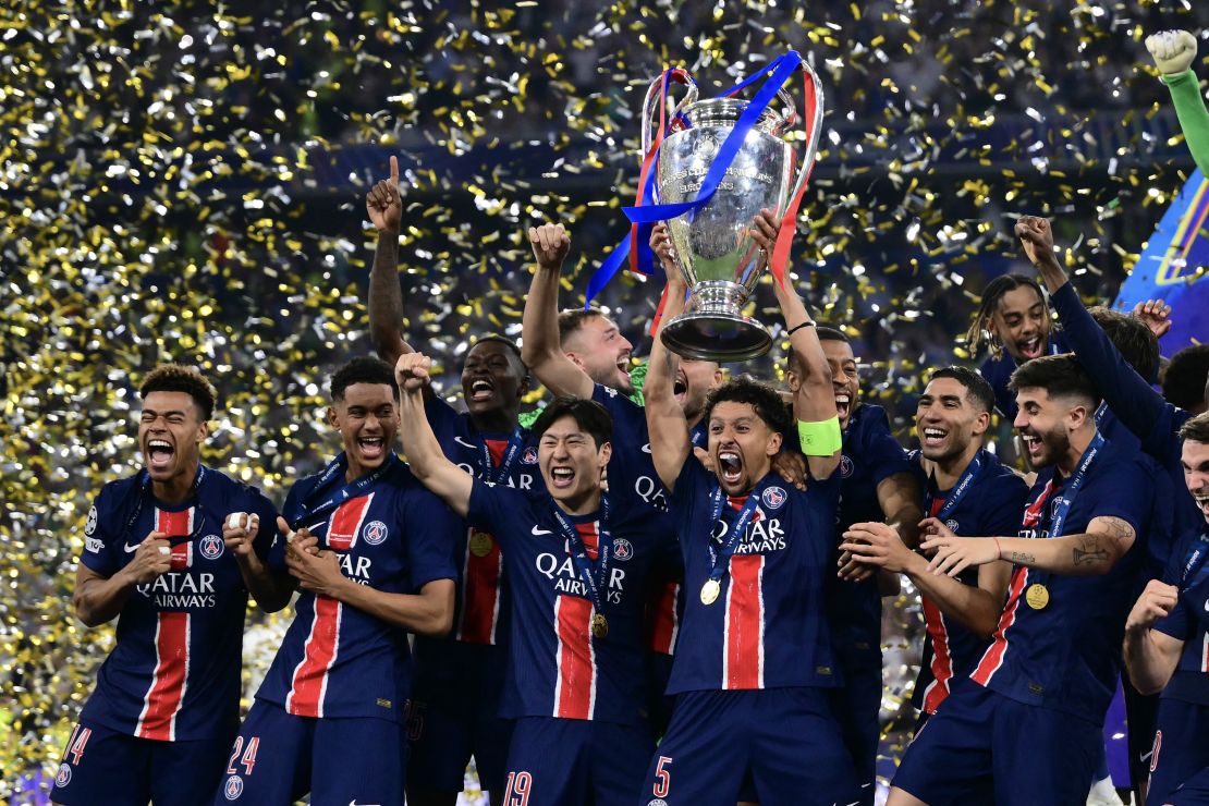 PSG players celebrate with the trophy after winning the club's first Champions League title.