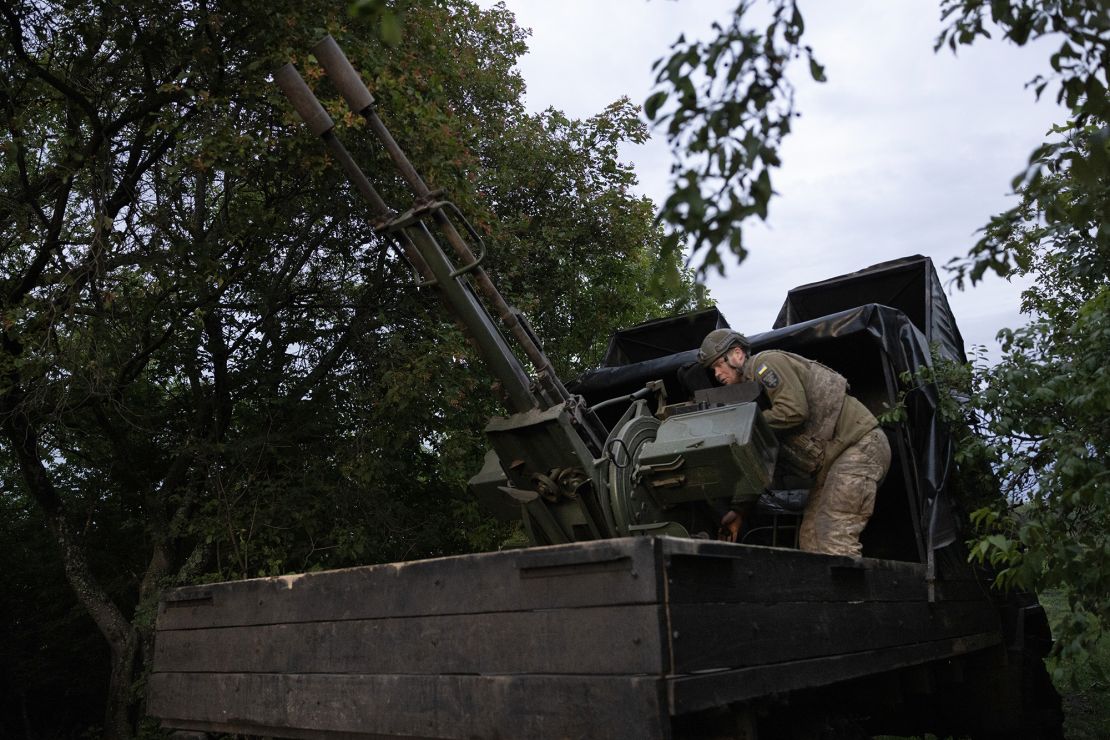 A Ukrainian soldier sets up his weapon in Kharkiv region in May.