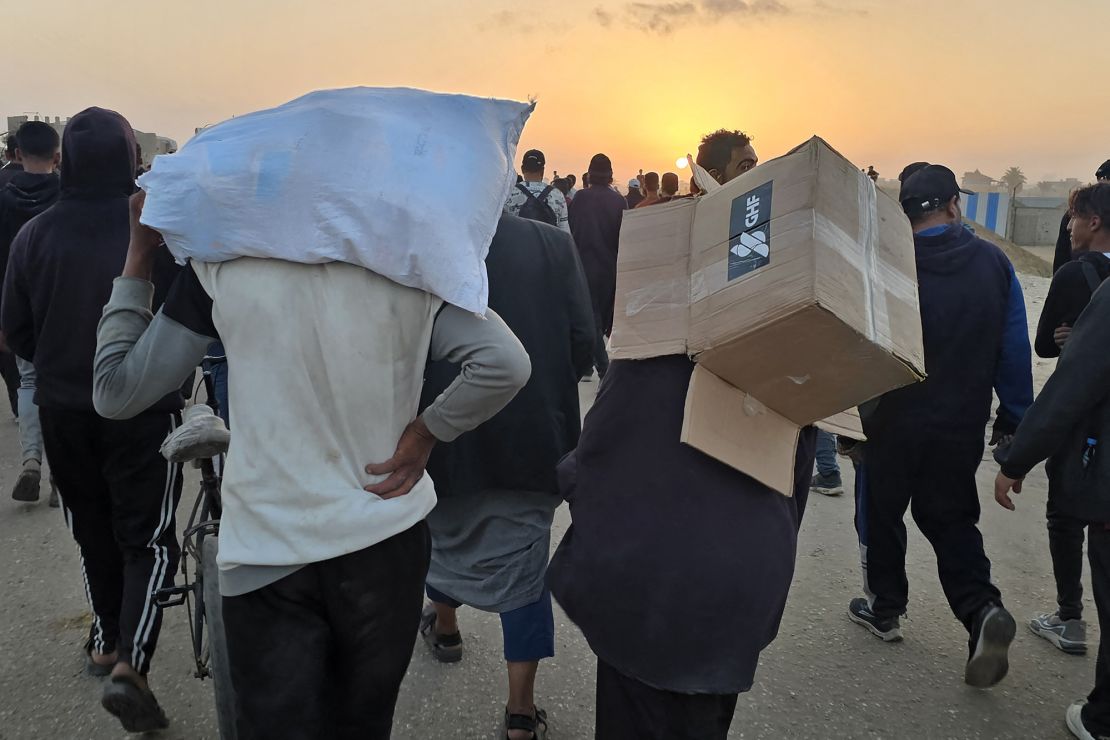 A Palestinian man carries an empty box of relief supplies from the Gaza Humanitarian Foundation near the group's distribution point in Rafah, southern Gaza, on Sunday, June 1, 2025.