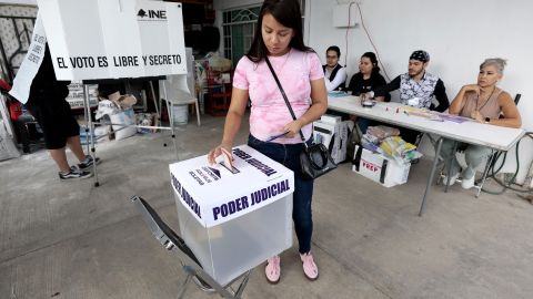 A woman exits the voting booth at a polling station during the world-first Mexican elections for all judges and magistrates in Guadalajara, Jalisco state, Mexico on June 1, 2025. Polls opened Sunday in elections making Mexico the world's only country to select its judges at all levels by popular vote. (Photo by STRINGER / AFP) (Photo by STRINGER/AFP via Getty Images)          