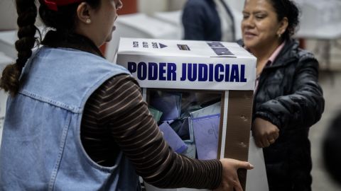 of the National Electoral Institute carry an urn with votes after polling stations closed in Mexico City on June 1, 2025. Mexico held unprecedented elections Sunday allowing voters to choose their judges, in a country where drug cartels and other vested interests regularly seek to alter the course of justice. (Photo by Carl de Souza / AFP) (Photo by CARL DE SOUZA/AFP via Getty Images)