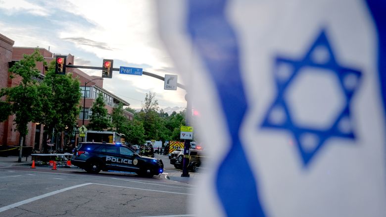 An Israeli flag is fixed to a street sign as police stand by off Pearl Street on the scene of an attack on demonstrators calling for the release of Israeli hostages held in Gaza, in Boulder, Colorado, on June 1, 2025. Several people suffered burns and other injuries June 1st in the US state of Colorado in what the FBI called a "targeted terror attack" against demonstrators seeking the release of Israeli hostages held in Gaza.
Police in the city of Boulder said a man was taken into custody. They were more cautious in presuming a possible motive for the attack, which multiple sources said was committed against members of the Jewish community during a peaceful gathering. (Photo by Eli Imadali / AFP) (Photo by ELI IMADALI/AFP via Getty Images)          