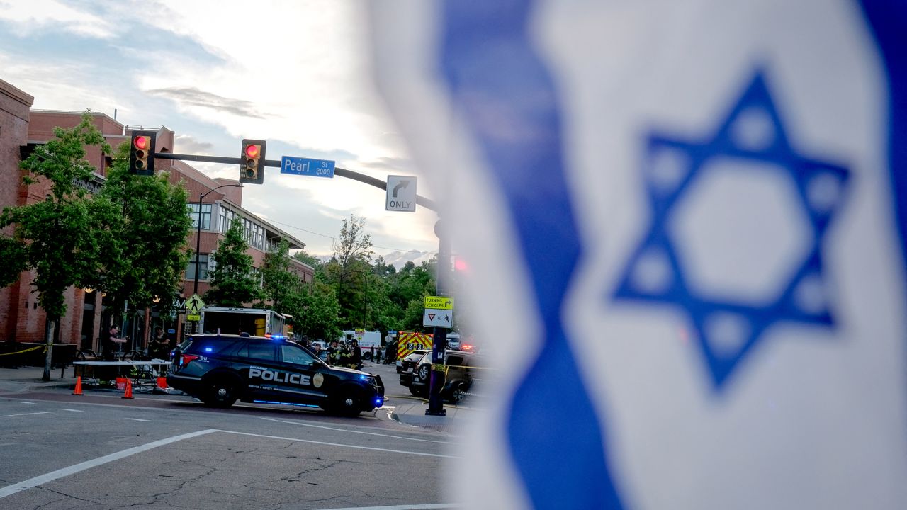 An Israeli flag is fixed to a street sign as police stand by off Pearl Street on the scene of an attack on demonstrators calling for the release of Israeli hostages held in Gaza, in Boulder, Colorado, on June 1, 2025. Several people suffered burns and other injuries June 1st in the US state of Colorado in what the FBI called a "targeted terror attack" against demonstrators seeking the release of Israeli hostages held in Gaza.
Police in the city of Boulder said a man was taken into custody. They were more cautious in presuming a possible motive for the attack, which multiple sources said was committed against members of the Jewish community during a peaceful gathering. (Photo by Eli Imadali / AFP) (Photo by ELI IMADALI/AFP via Getty Images)          