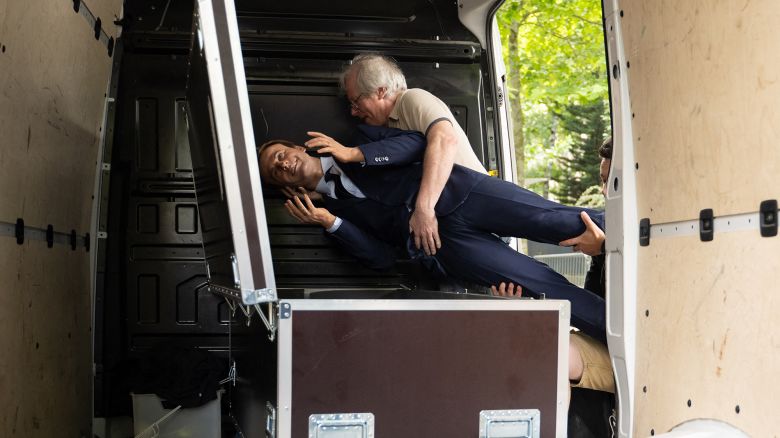 Greenpeace environmental activists place a wax statue of depicting France's President Emmanuel Macron in a box in the back of a van - they say they stole earlier at the Grevin Museum - after an action against France's gas and fertilizer imports from Russia, outside the Russian Embassy in Paris on June 2, 2025. According to a police source, two women and a man entered the Grevin Museum posing as tourists and, once inside, changed their clothes to pass for workers. The activists slipped out through an emergency exit with the 40,000-euro-statue, which they had covered with a blanket. (Photo by Emma DA SILVA / AFP) (Photo by EMMA DA SILVA/AFP via Getty Images)          