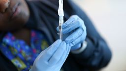 In this photo illustration, Ruth Jones, Immunization Nurse, holds a Pfizer-BioNTech COVID-19 vaccine at Borinquen Health Care Center in Miami, Florida on May 29, 2025.