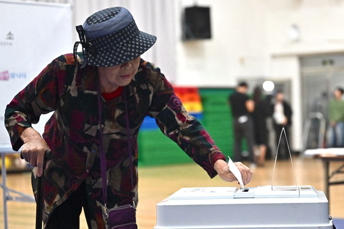 A woman casts her vote at a polling station in Seoul during the presidential election on June 3, 2025.