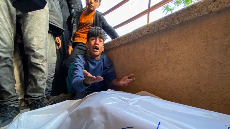 Palestinians mourn by the bodies of relatives who were killed by Israeli fire as they gathered near a US-backed aid center in the Rafah area, at the Nasser hospital in the southern Gaza Strip on June 3, 2025.