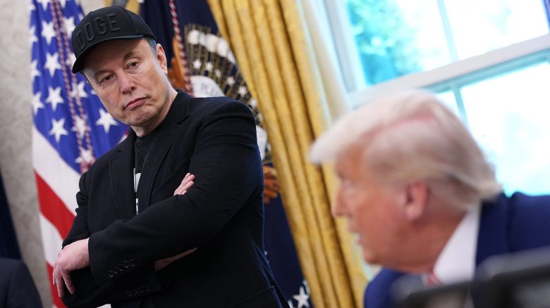 Elon Musk listens as President Donald Trump speaks to reporters in the Oval Office of the White House earlier this year.