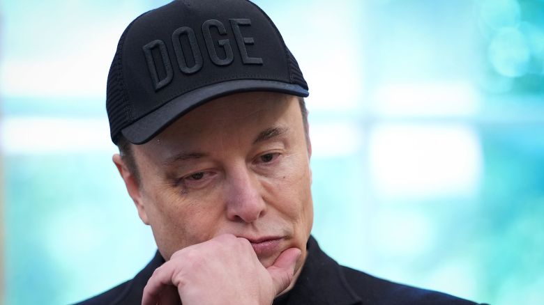 Elon Musk wears a DOGE hat in the Oval Office of the White House on May 30.