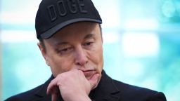 Tesla CEO Elon Musk listens as U.S. President Donald Trump speaks to reporters in the Oval Office of the White House on May 30, 2025 in Washington, DC. Musk, who served as an adviser to Trump and led the Department of Government Efficiency, announced he would leave his role the Trump administration to refocus on his businesses.