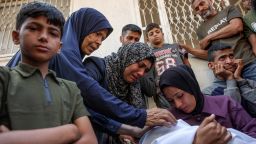 A woman mourns over the body of a Palestinian killed by an Israeli airstrike at Al-Shifa hospital in Gaza City on June 4, 2025.
