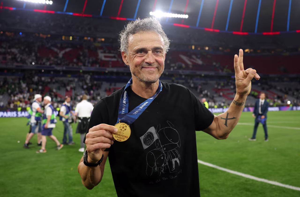 PSG manager Luis Enrique shows off his winner's medal.