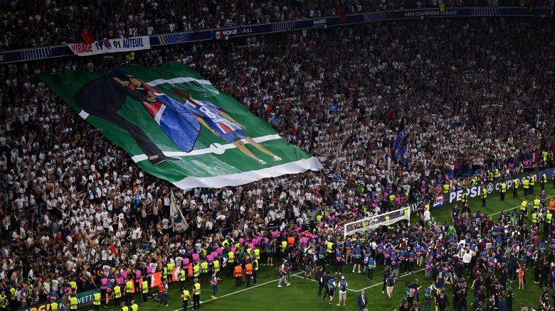 Fans of Paris Saint-Germain display a banner in tribute to Xana Martinez, daughter of Luis Enrique, after PSG beat FC Internazionale to secure Paris Saint-Germain's first ever UEFA Champions League title Saturday in Munich.