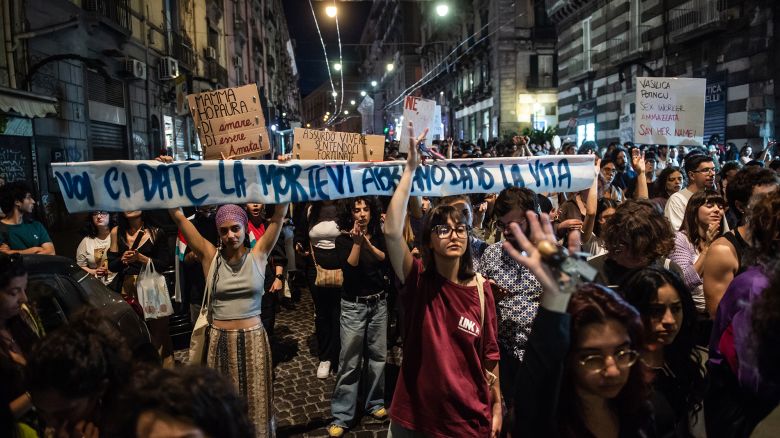 NAPLES, ITALY - MAY 29: Two women hold up signs that read: "Voi ci date la morte"(You give us death) and Vi abbiamo dato la vita"" (We gave you life) during a demonstration against femicide and gender violence after the discovery of Martina Carbonaro's body on May 29, 2025 in Naples, Italy. The body of 14-year-old Martina Carbonaro was found in an abandoned building near a sports center in Afragola. It was a femicide, her ex-boyfriend Alessio Tucci, a 19-year-old also from Afragola, confessed to killing her because he could not accept the end of the relationship. In many Italian cities, torchlight processions have been organized to say stop to gender violence and feminicides. (Photo by Ivan Romano/Getty Images)