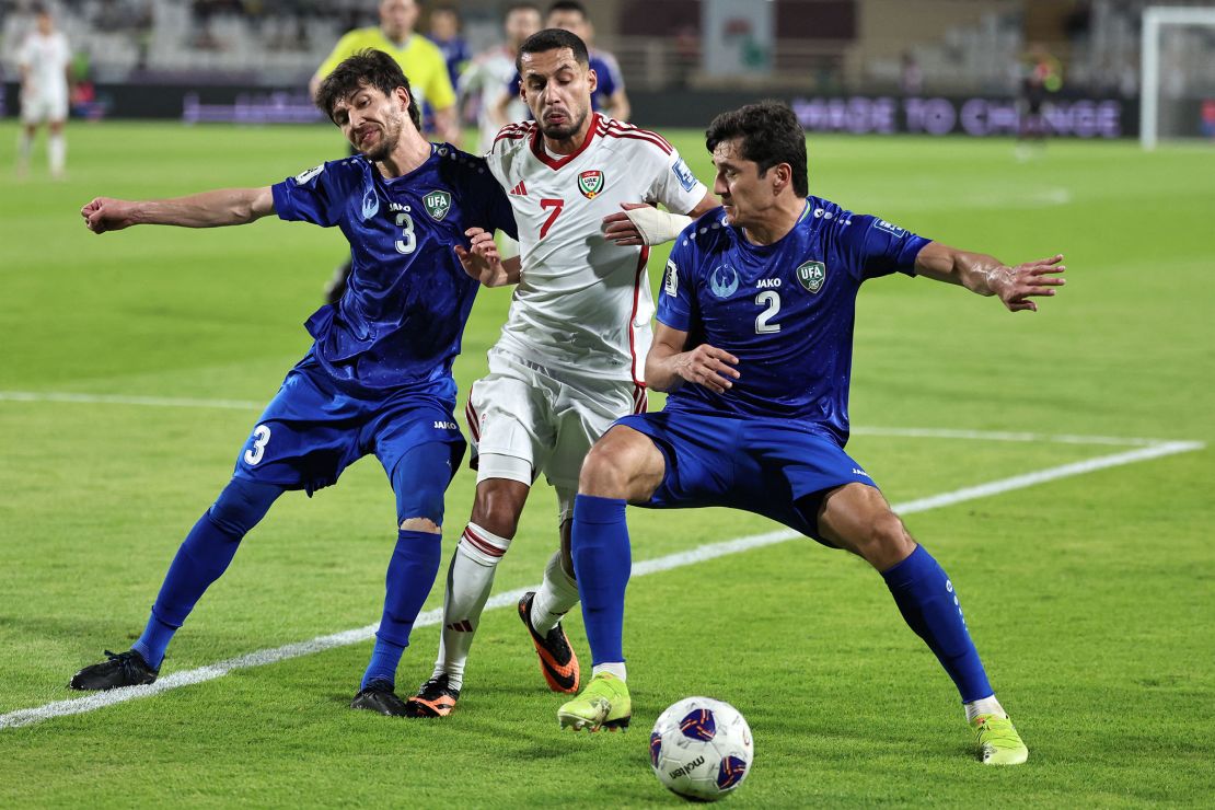 Uzbekistan defenders Khojiakbar Alijonov, left and Abdukodir Khusanov, right, vie for the ball against UAE's forward Ali Saleh, center, during the 2026 FIFA World Cup Asian Qualifier football match between the United Arab Emirates and Uzbekistan.