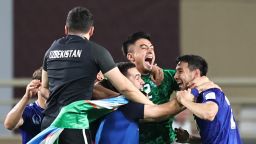 Uzbekistan's players celebrate after their 2026 FIFA World Cup Asian Qualifier football match against the United Arab Emirates ended in a draw, qualifying them for the World Cup for the first time, at Al-Nahyan Stadium in Abu Dhabi on June 5, 2025.