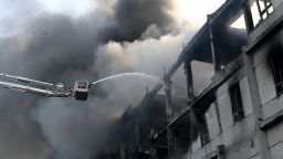 TOPSHOT - A firefighter extinguishes a fire at a civilian plant following Russian powerful attacks on the Ukrainian city of Kharkiv early on June 7, 2025, amid the Russian invasion of Ukraine. Russia unleashed a barrage of missiles, drones and bombs across Ukraine early on June 7, killing at least five people in a major attack that the mayor of Kharkiv, Ukraine's second largest city, described as unprecedented. (Photo by SERGEY BOBOK / AFP) (Photo by SERGEY BOBOK/AFP via Getty Images)          