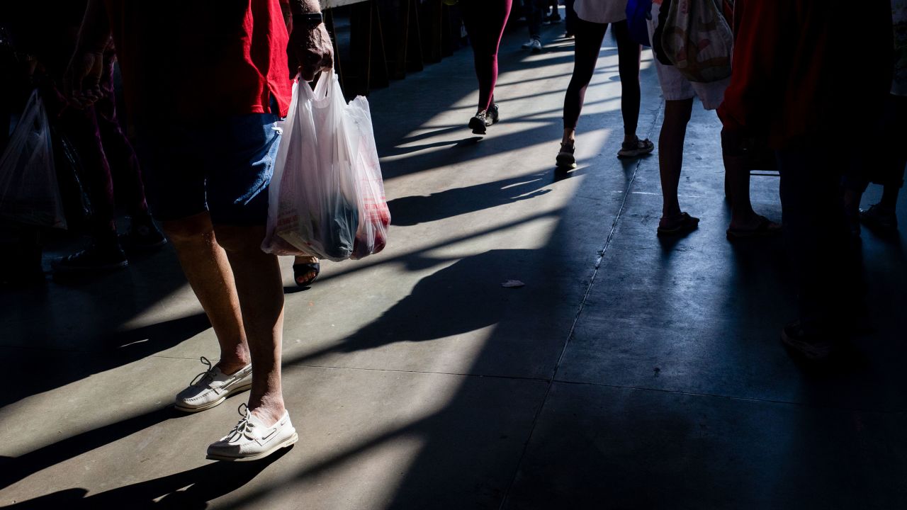 A shopper carries a bag at a market in Detroit, Michigan, US, on Saturday, June 7, 2025.