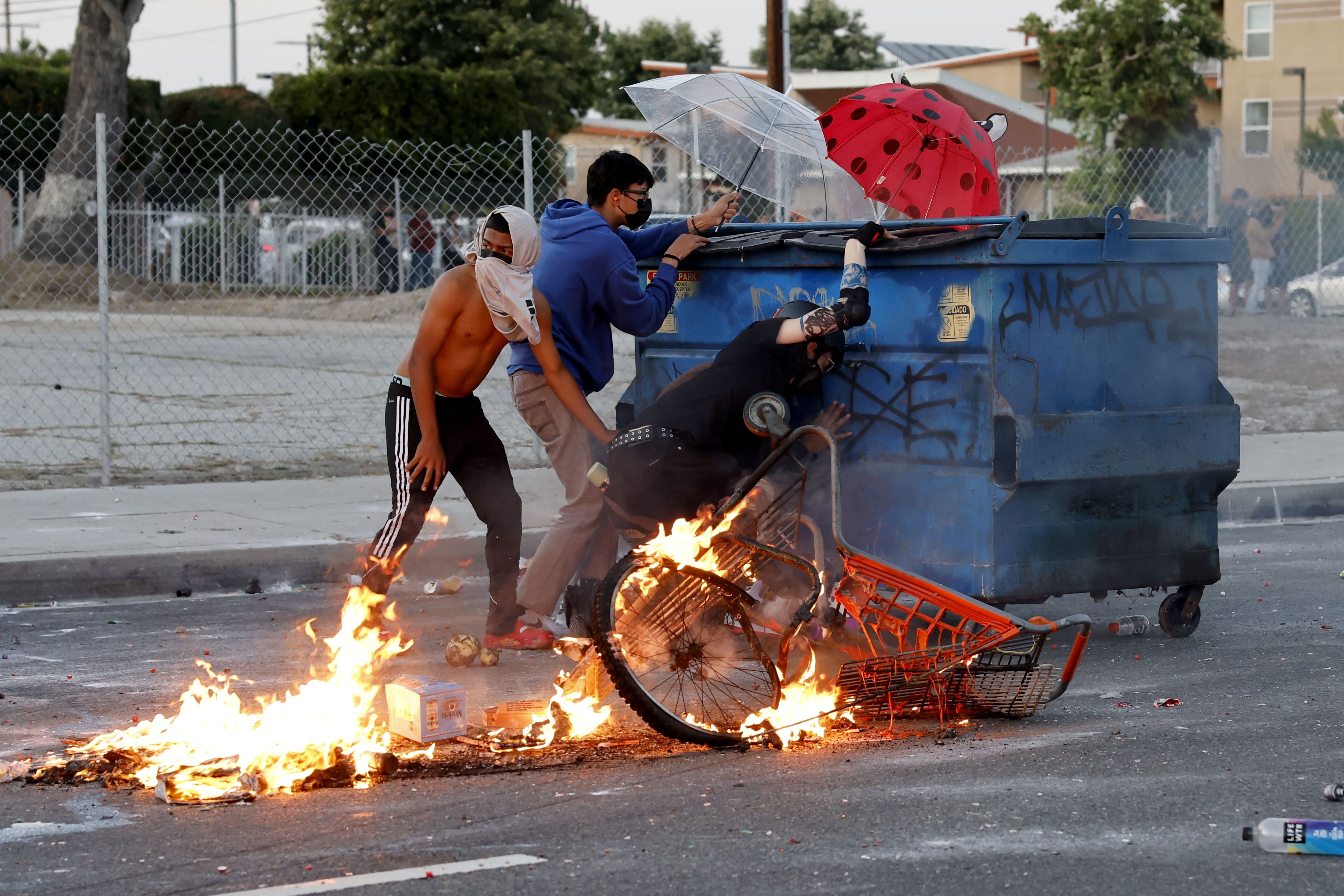 Protesters shield themselves against law enforcement during a protest in Compton on Saturday.