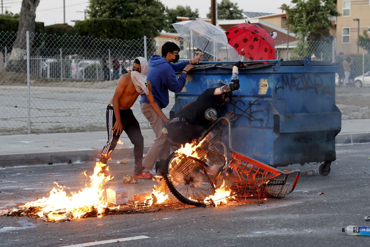 Protesters shield themselves against law enforcement during a protest on Saturday.