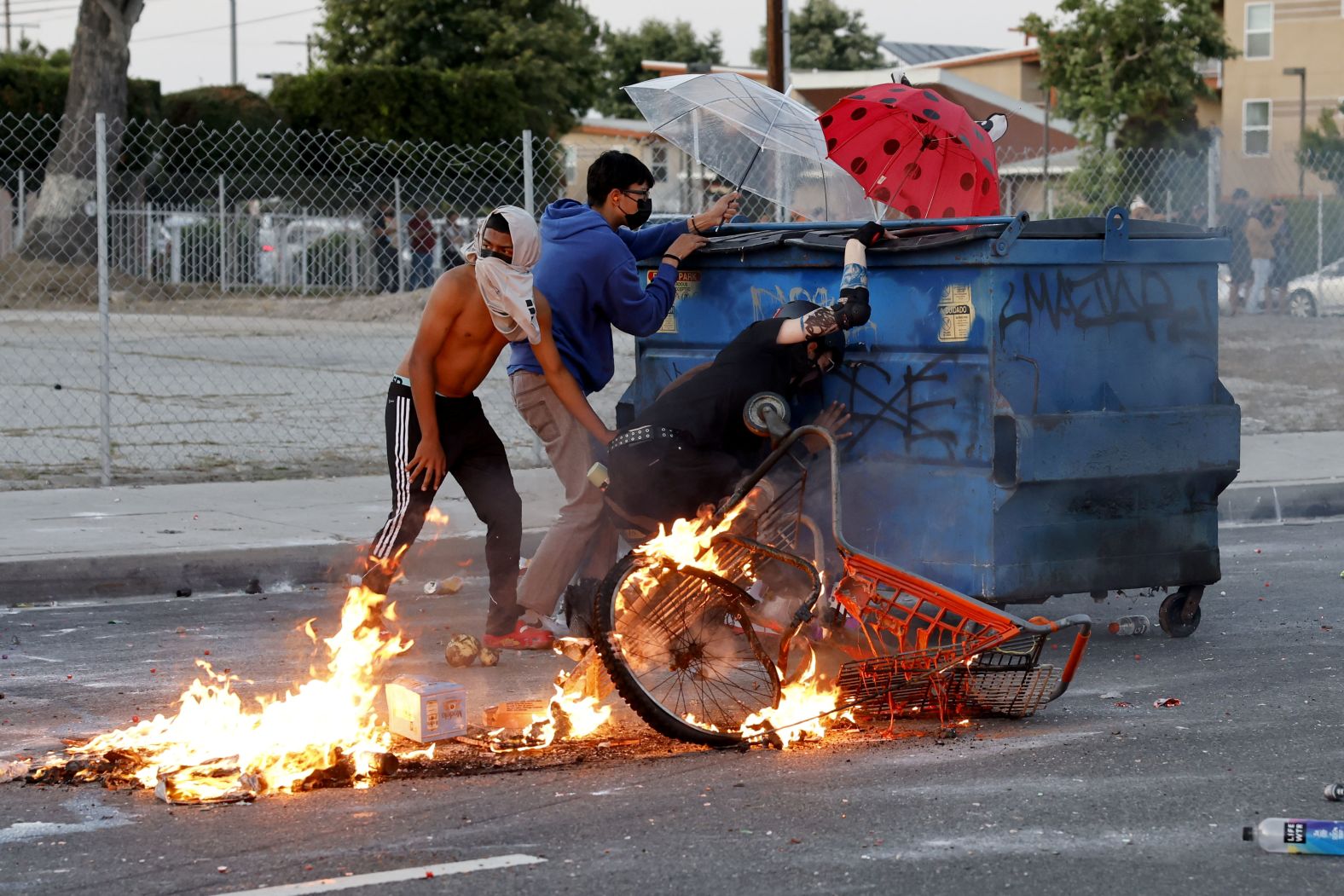 Protesters shield themselves against law enforcement during a protest in Compton, Los Angeles, on Saturday.