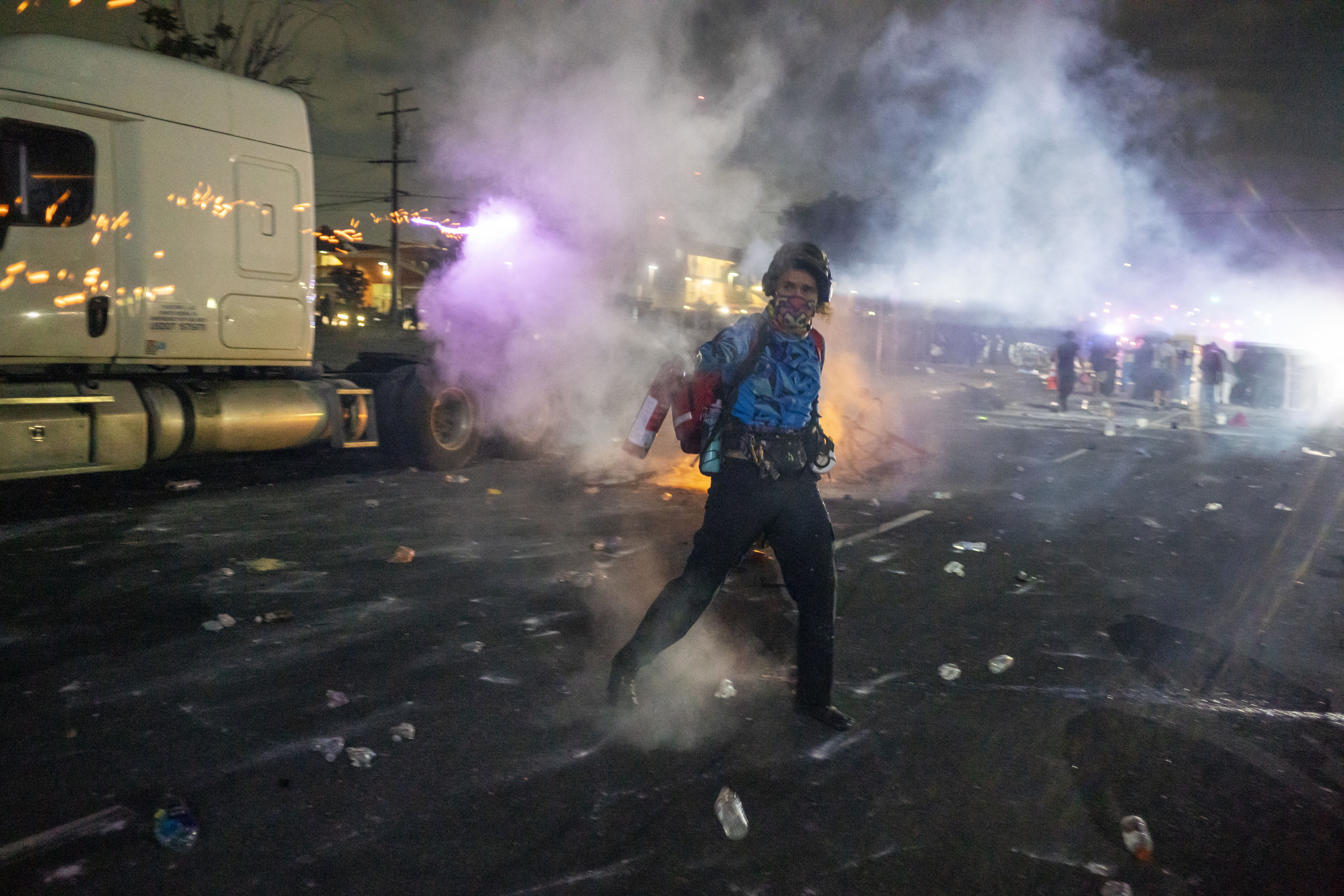 A protester reacts as law enforcement clashes with demonstrators in Compton on Saturday.
