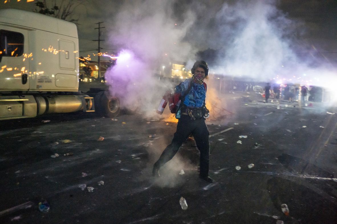 A protester reacts as law enforcement officers clash with demonstrators on Saturday.